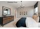 Stylish bedroom featuring skateboard decor and a modern dresser with mirror at 11020 Tyler Brook Ln # Oak0035, Mint Hill, NC 28227