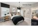 Modern bedroom with natural light, skater art, and a view into the ensuite bathroom at 11020 Tyler Brook Ln # Oak0035, Mint Hill, NC 28227