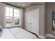 Bright bedroom featuring a large window and closet with bi-fold doors at 11020 Tyler Brook Ln # Oak0035, Mint Hill, NC 28227