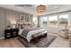 Comfortable bedroom with lots of natural light, textured wall, and neutral color palette at 11020 Tyler Brook Ln # Oak0035, Mint Hill, NC 28227