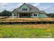 New home in construction phase with visible house wrap and windows installed at 11020 Tyler Brook Ln # Oak0035, Mint Hill, NC 28227