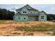 New home under construction with visible house wrap and framing, ready for customization at 11020 Tyler Brook Ln # Oak0035, Mint Hill, NC 28227