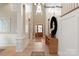 Elegant foyer showcasing high ceilings, paneled walls, hardwood floors, and stylish decor at 11020 Tyler Brook Ln # Oak0035, Mint Hill, NC 28227