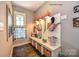 Mudroom featuring custom bench with storage, statement lighting, and decorative window treatment at 11020 Tyler Brook Ln # Oak0035, Mint Hill, NC 28227