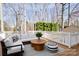 A cozy back deck features outdoor seating, a small table, and a view of the green backyard at 11121 Timber Hill Ct, Charlotte, NC 28226