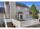 A spacious backyard deck with white railings overlooking the yard and mature trees at 11121 Timber Hill Ct, Charlotte, NC 28226