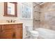 Bathroom with a wooden vanity, patterned shower and a window providing natural light at 11121 Timber Hill Ct, Charlotte, NC 28226