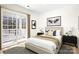 Comfortable bedroom with sliding glass doors to a patio, neutral color palette, and tasteful decor at 11121 Timber Hill Ct, Charlotte, NC 28226