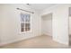 Bright bedroom featuring a window with natural light, a spacious closet and neutral carpeting at 11121 Timber Hill Ct, Charlotte, NC 28226