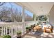 Inviting covered front porch features seating and potted plants offering a tranquil outdoor space at 11121 Timber Hill Ct, Charlotte, NC 28226