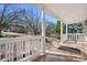 Spacious tiled front porch with white pillars, offering a welcoming entrance to the home at 11121 Timber Hill Ct, Charlotte, NC 28226