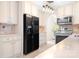 Bright kitchen features white cabinets, modern stainless steel appliances, and tile backsplash at 11121 Timber Hill Ct, Charlotte, NC 28226