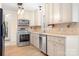 Well-lit kitchen features stainless steel appliances, and cream colored cabinetry at 11121 Timber Hill Ct, Charlotte, NC 28226