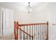 Elegant staircase with wooden banister and wrought iron spindles at 11121 Timber Hill Ct, Charlotte, NC 28226