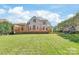 Spacious backyard with an expansive wooden deck, lush lawn and a playset at 11130 Mccamie Hill Pl, Concord, NC 28025