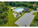 Aerial view of a community pool, playground, sand volleyball court, ample parking, and lush landscaping at 11130 Mccamie Hill Pl, Concord, NC 28025