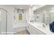 Bathroom featuring a garden tub, double sink vanity, and natural light from the window at 112 Woodhall Way, Troutman, NC 28166