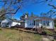 Charming single-story home featuring a classic white exterior with a detached garage and mature trees at 1142 Camden Ave, Rock Hill, SC 29732