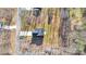 An aerial view of a charming home with a driveway and lush greenery at 120 Orville Rd, Statesville, NC 28677
