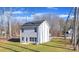 Backyard view of the home, showcasing a well-maintained lawn, mature trees, and a serene outdoor space at 120 Orville Rd, Statesville, NC 28677