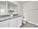 Bathroom featuring granite countertop, white cabinet, large mirror and toilet at 120 Orville Rd, Statesville, NC 28677