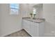 Bathroom with dual sinks, granite countertops, and a large mirror at 120 Orville Rd, Statesville, NC 28677