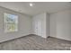 A bright bedroom featuring a window overlooking the neighborhood at 120 Orville Rd, Statesville, NC 28677