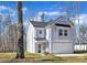 Charming two-story home with an attached garage and manicured lawn against a serene wooded backdrop at 120 Orville Rd, Statesville, NC 28677