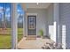 Welcoming front porch featuring a stylish black front door with glass panes and neutral siding at 120 Orville Rd, Statesville, NC 28677
