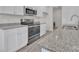 Modern kitchen with stainless steel appliances, granite countertops and sink, and white cabinets offers stylish cooking space at 120 Orville Rd, Statesville, NC 28677