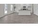 An open space featuring hardwood floors and modern kitchen with large island and stainless appliances at 120 Orville Rd, Statesville, NC 28677