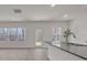 Bright kitchen features granite countertops, stainless steel faucet, and natural light from the windows and door at 120 Orville Rd, Statesville, NC 28677