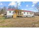 Charming single-story home featuring a vibrant red roof and inviting covered front porch at 1216 Brief W Rd, Indian Trail, NC 28079