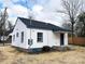 Rear exterior of a newly renovated home showcasing white siding and a dark roof at 123 Oak St, Chester, SC 29706