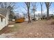 Large backyard featuring a storage shed, mature trees, and ample space for outdoor activities and entertaining at 1275 Rocky Creek Rd, Shelby, NC 28152