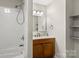 Bathroom with a shower/tub combo, tiled walls, vanity with wooden cabinets, and shelving at 1275 Rocky Creek Rd, Shelby, NC 28152