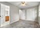 Bedroom featuring a ceiling fan, gray carpet, a view into the attached bathroom, and a closet at 1275 Rocky Creek Rd, Shelby, NC 28152