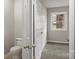 View of a door leading to a toilet and a bedroom with wall-to-wall gray carpet at 1275 Rocky Creek Rd, Shelby, NC 28152