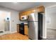 Kitchen features wood cabinets, black appliances and wood flooring at 1275 Rocky Creek Rd, Shelby, NC 28152