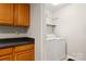 Off the kitchen is the laundry room with washer, dryer, and shelving at 1275 Rocky Creek Rd, Shelby, NC 28152