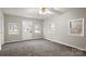 Bright living room features neutral paint, carpet flooring, and large windows for natural light at 1275 Rocky Creek Rd, Shelby, NC 28152