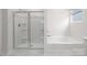 Bright bathroom featuring a soaking tub and a separate walk-in shower at 130 Woodhall Way, Troutman, NC 28166
