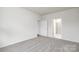A bright bedroom featuring neutral carpeting and two doors at 130 Woodhall Way, Troutman, NC 28166
