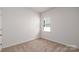 Bedroom with neutral carpeting and a window with blinds at 130 Woodhall Way, Troutman, NC 28166