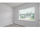 Bedroom featuring a window with blinds and neutral carpeting at 130 Woodhall Way, Troutman, NC 28166