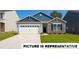 Charming single-story home featuring stone accents, a two-car garage, and a well-manicured lawn at 130 Woodhall Way, Troutman, NC 28166