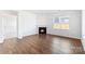 Inviting living room featuring hardwood floors, a classic fireplace, and an abundant amount of natural light at 130 Woodhall Way, Troutman, NC 28166