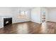 Bright living room featuring a fireplace, hardwood floors, and natural light at 130 Woodhall Way, Troutman, NC 28166