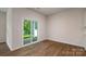 Living room featuring hardwood floors, a glass sliding door leading to a patio and abundant natural light at 130 Woodhall Way, Troutman, NC 28166