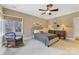 Cozy bedroom with neutral tones, a wicker chair, and a large window with natural light at 1307 Wyndmere Hills Ln, Matthews, NC 28105